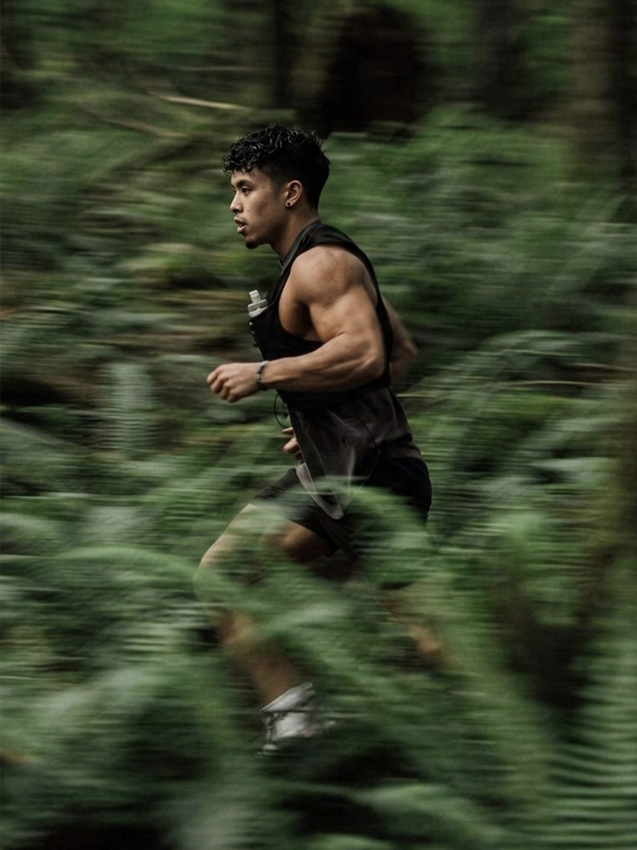 Runner moving through a lush green forest